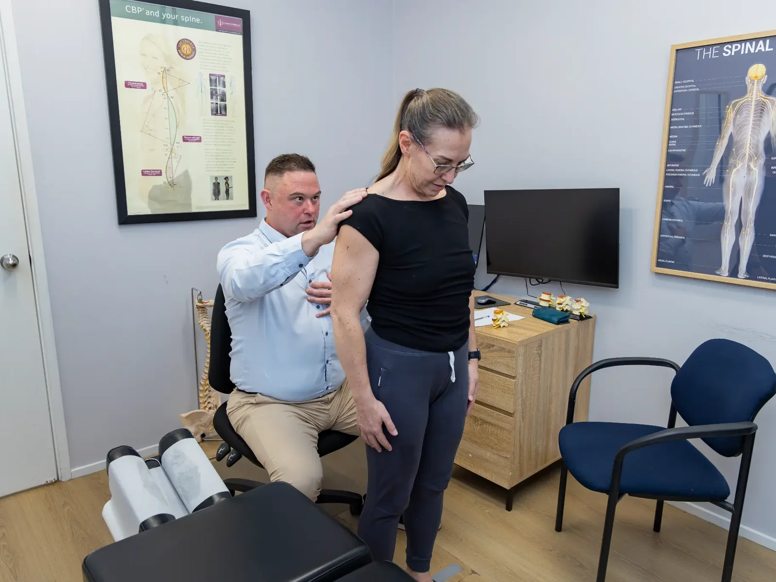 Dr Michael Charlton completing a considered movement assessment with an adult patient at Charlton Chiropractic Redbank